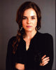 Zoey Deutch photo print in black sweater with arms crossed.