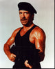 Chuck Norris Delta Force 2 Photo Print featuring him in action holding a gun and wearing a beret.