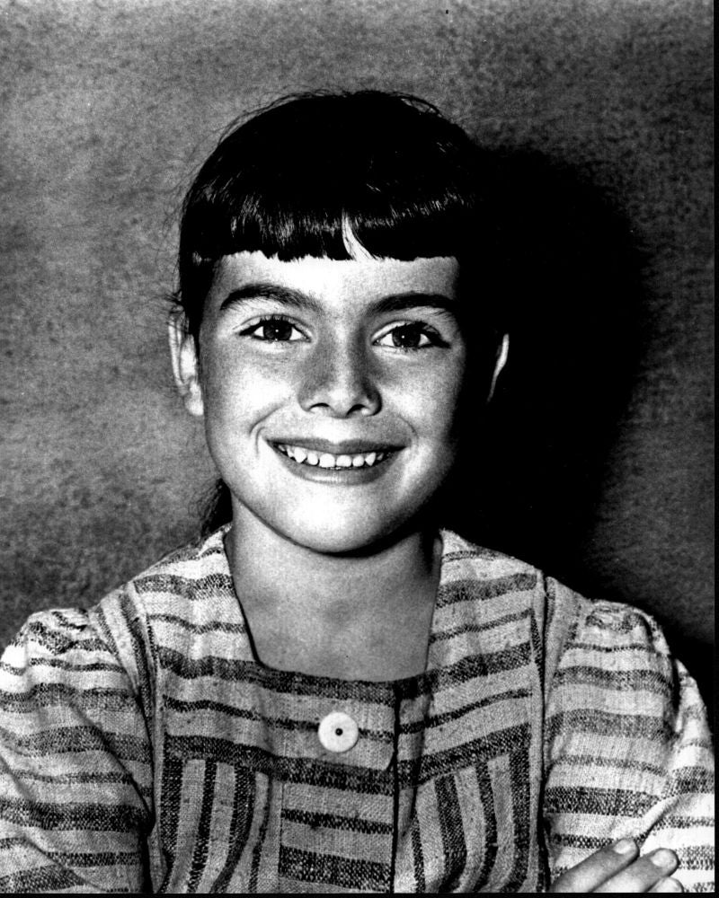 Black and white photo print of Debbie Turner in a striped dress.