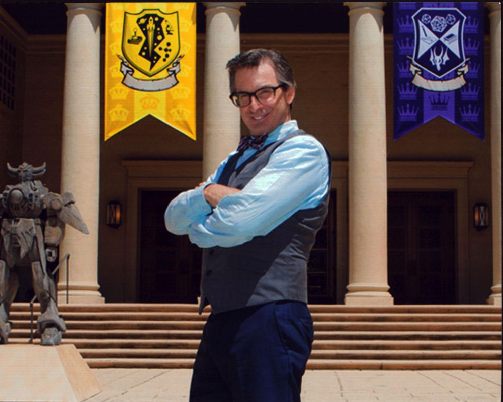 Robert Carradine photo print with arms crossed in front of King of the Nerds banners.