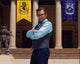 Robert Carradine photo print with arms crossed in front of King of the Nerds banners.