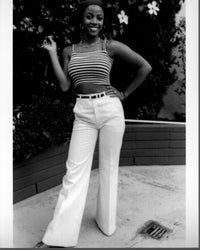 Bern Nadette Stanis black and white photo print in a striped top and white pants.