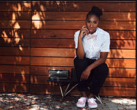 Lena Waithe Sitting In Front Of Wood Wall With Typewriter Photo Print