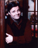 Nathan Lane photo print in red top and black vest, arms crossed.