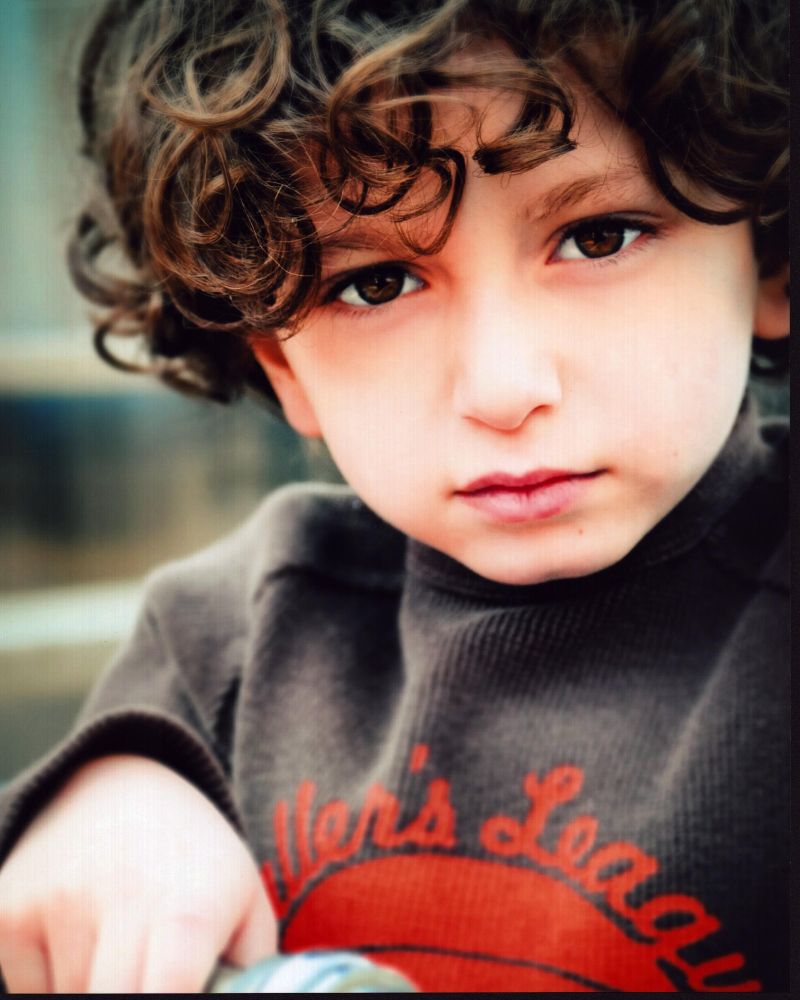 August Maturo close-up photo print in gray and orange shirt
