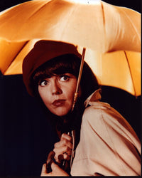 Barbara Feldon holding a yellow umbrella photo print.