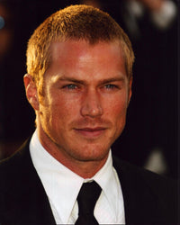 Close-up photo print of Jason Lewis in a black suit and tie.