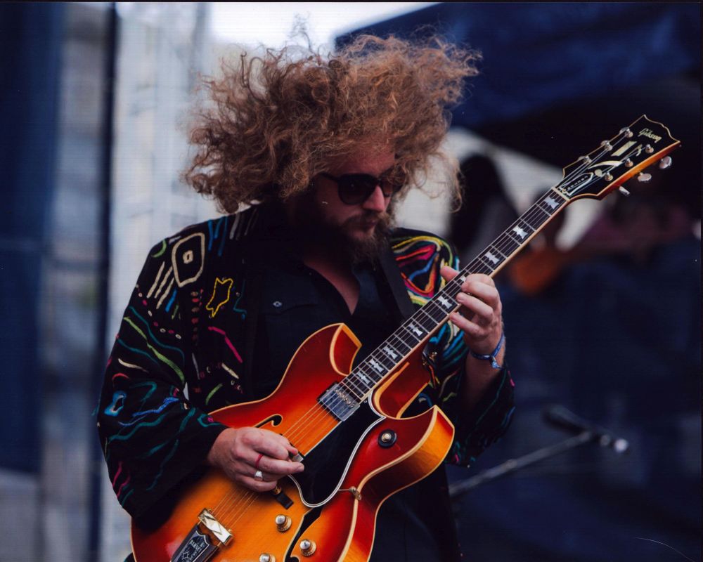 Jim James playing guitar on stage photo print