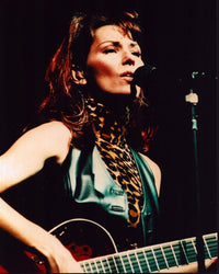 Shania Twain performing on stage in animal print turtleneck and black leather vest photo print.