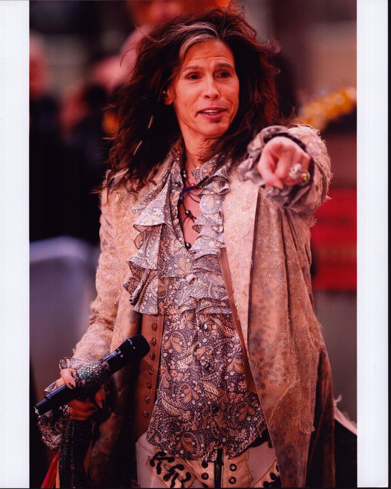 Steven Tyler pointing in a tan jacket with paisley ruffle top photo print.