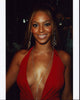 Beyoncé stunning photo print in low cut red top and diamond necklace.