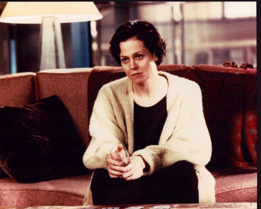 Sigourney Weaver Sitting in Sweater Photo Print - Cozy and stylish.
