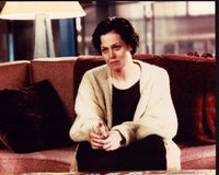 Sigourney Weaver Sitting in Sweater Photo Print - Cozy and stylish.