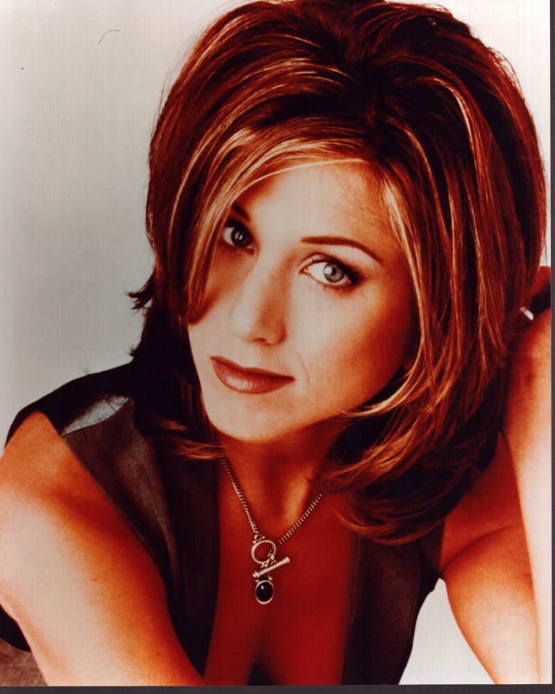 Jennifer Aniston close-up photo print in gray vest with hand in hair.