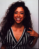 Liza Koshy smiling in a black and white striped top photo print.
