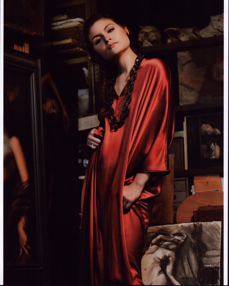 Phillipa Soo photo print in orange silk dress, vibrant and elegant.