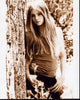 Willow Shields leaning on tree photo print showcasing serene nature beauty.