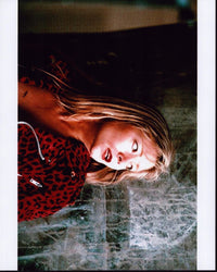 Theresa Russell in a red animal print jacket photo print