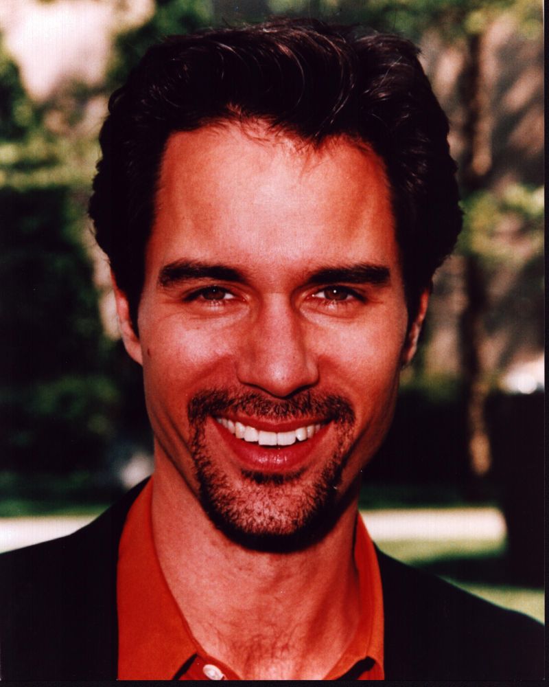 Eric McCormack photo print in black jacket and orange shirt