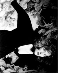Gillian Anderson leaning on a painting in black and white photo print