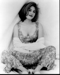 Gillian Anderson black and white photo print featuring her seated in a dress with a sweater around her arms.