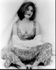 Gillian Anderson black and white photo print featuring her seated in a dress with a sweater around her arms.