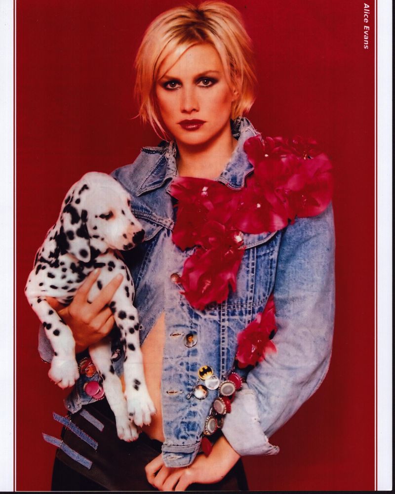 Alice Evans in denim jacket holding puppy photo print.