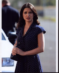 Andrea Gabriel in navy polka dot dress photo print.