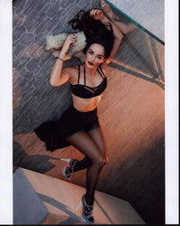 Ana De La Reguera laying on floor in stylish bra and skirt photo print.
