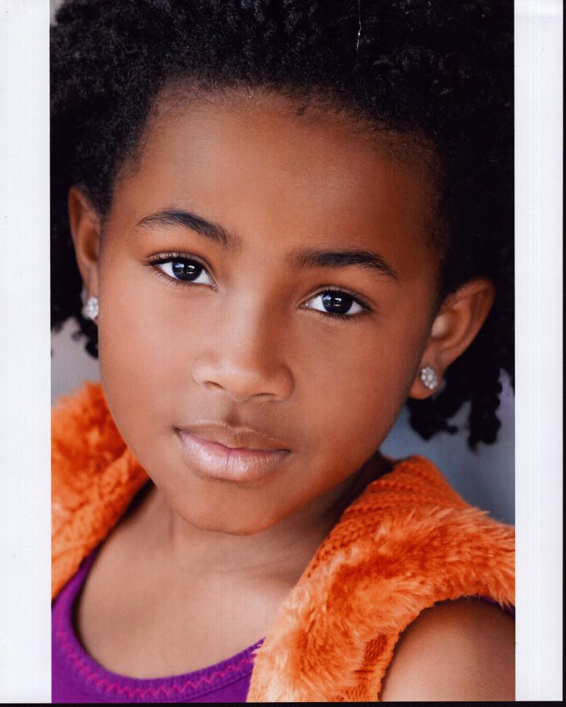 Layla Crawford headshot photo print in orange vest.