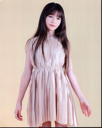 Malina Pauli Weissman in a tan dress photo print