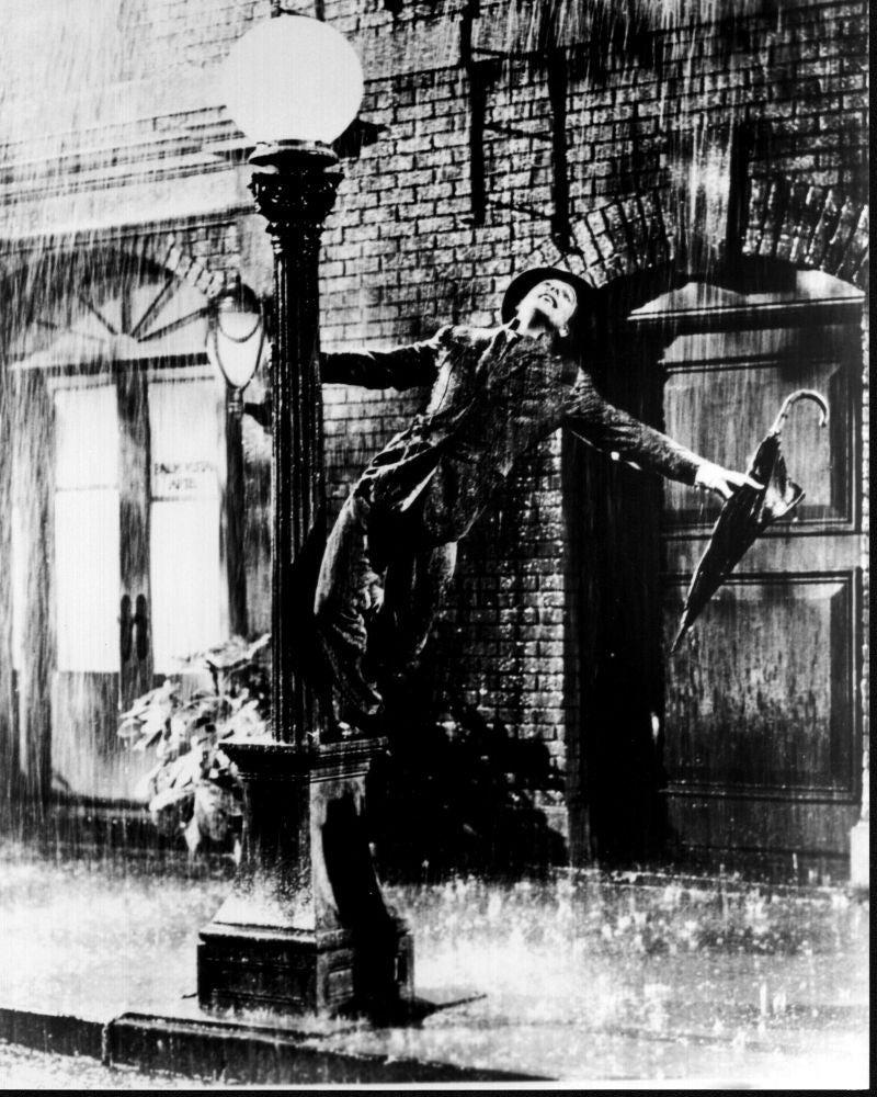 Gene Kelly Standing on Lamp Post in Singin' in the Rain Black and White Photo Print