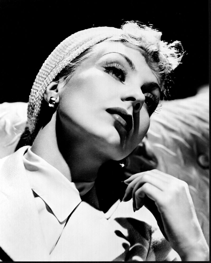Black and white photo print of Ann Sothern leaning back in a hat.