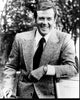 Black and white photo print of Roger Moore leaning on car door in Octopussy.