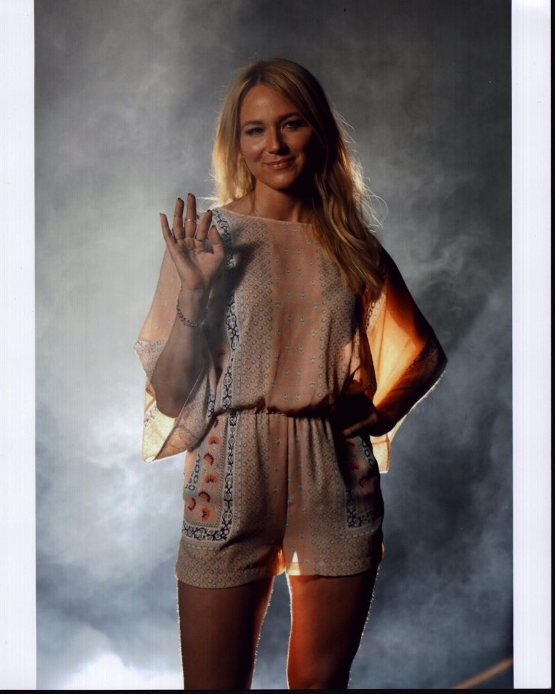 Jewel Waving In Patterned Romper Photo Print showcasing vibrant colors and intricate details.