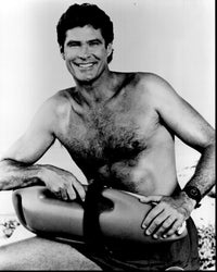 David Hasselhoff smiling with lifeguard float in black and white photo print.