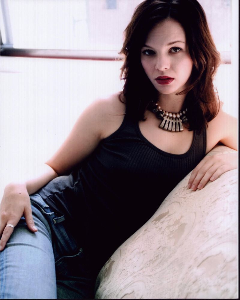 Amber Tamblyn sitting on couch in jeans and tank top photo print, stylish lifestyle portrait.