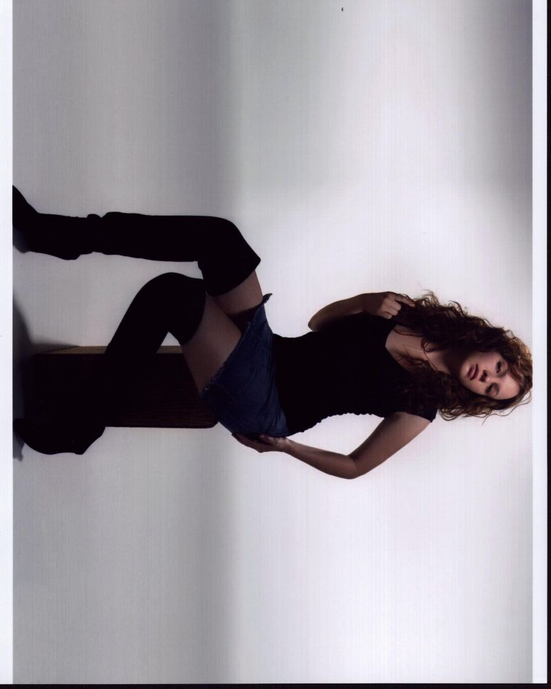 Amber Tamblyn posed on box in skirt and high boots photo print