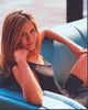 Jennifer Aniston in black dress sitting on blue couch photo print.