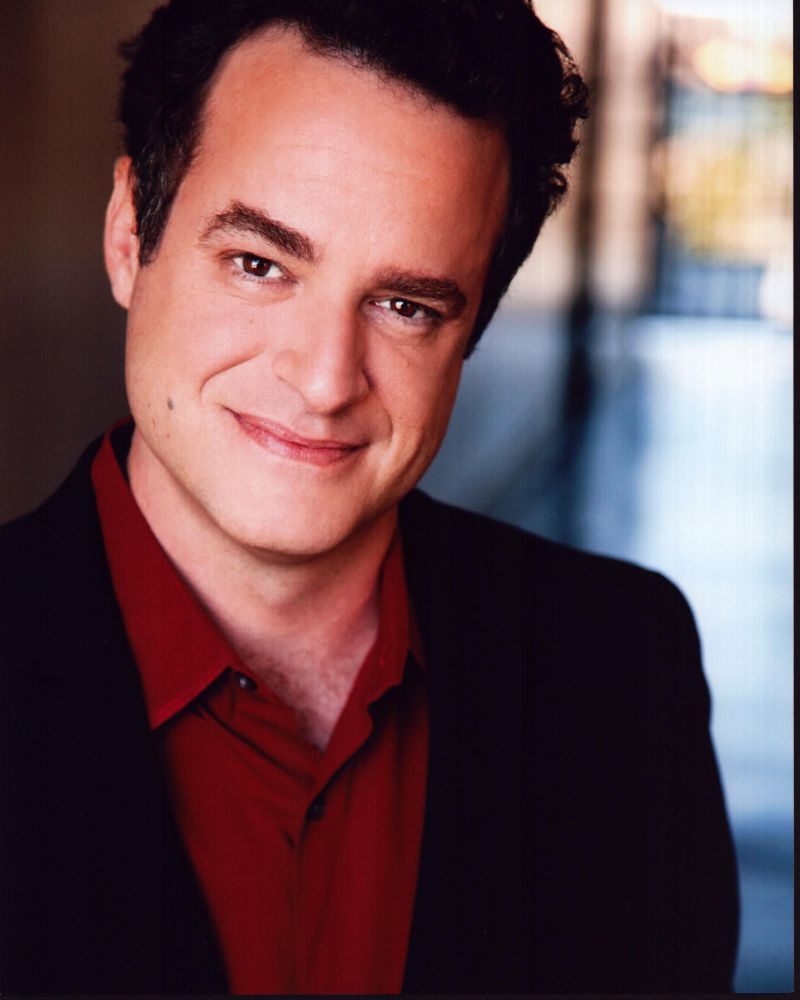 Matt Besser photo print featuring him in a red shirt and blazer.