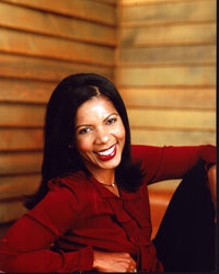Penny Johnson Jerald smiling in a red ruffle top photo print.