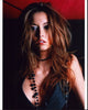 Taryn Southern photo print in black vest with beaded necklaces.