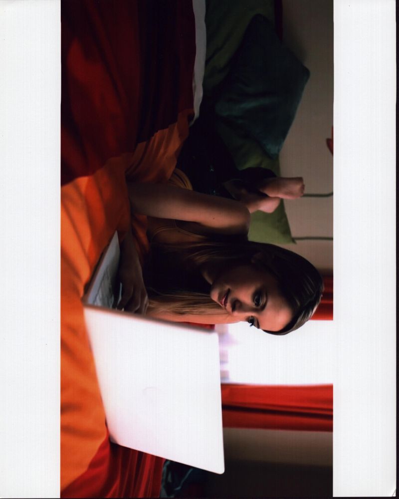 Taryn Southern Laying on Bed with Laptop Photo Print