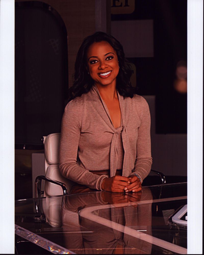 Nischelle Turner at Glass Desk Photo Print showcasing elegance and professionalism.