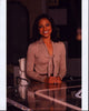 Nischelle Turner at Glass Desk Photo Print showcasing elegance and professionalism.
