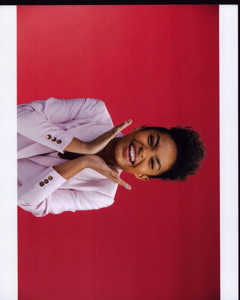 Yara Shahidi photo print with hands under face, elegant and captivating.