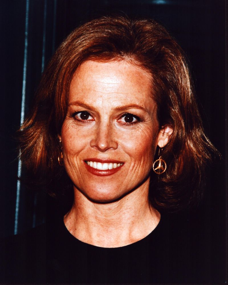 Close-up photo print of Sigourney Weaver in black top and gold earrings.