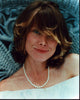 Sissy Spacek photo print in off shoulder white top and pearl necklace.