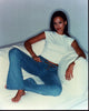 Jessica Alba relaxing on couch in jeans and shirt photo print