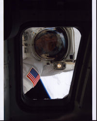 Mike Massimino looking through spaceship window photo print.